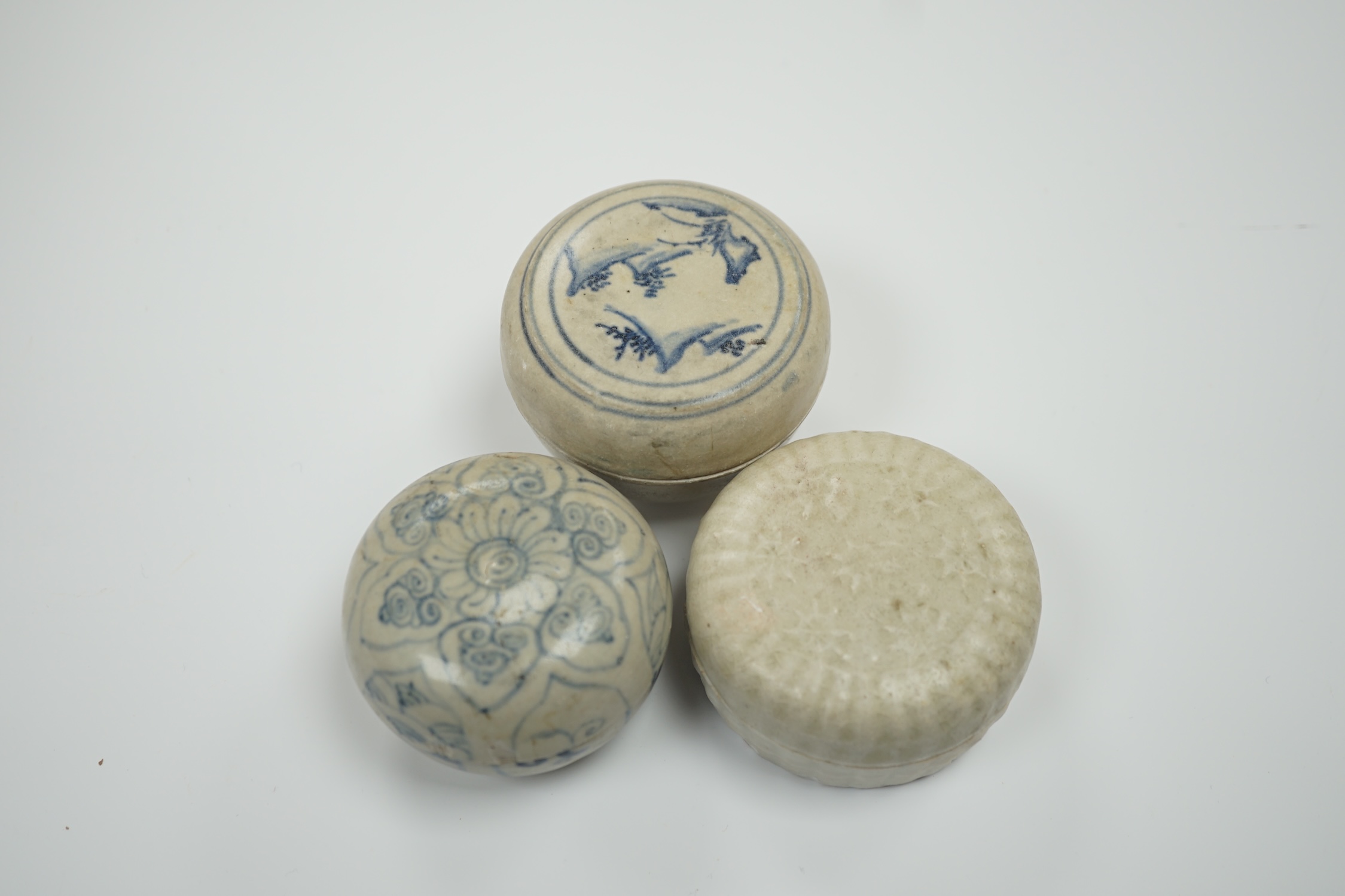 Two Annamese Chinese blue and white boxes and covers, 15th/16th century and a Dehua moulded box and cover, Ming dynasty